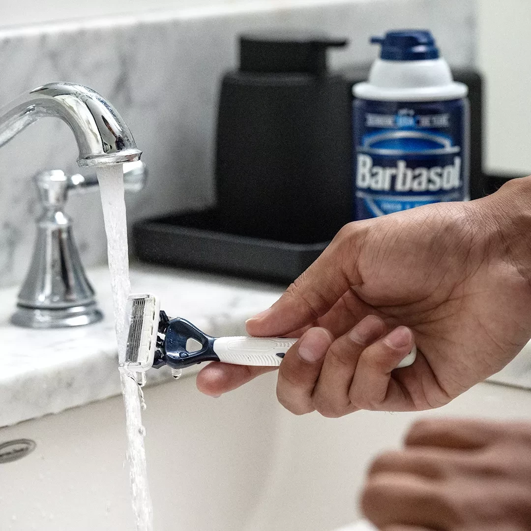 Barbasol Original Thick & Rich Shaving Cream, 10 Ounces - Sitting on sink counter while person washes Barbasol razors