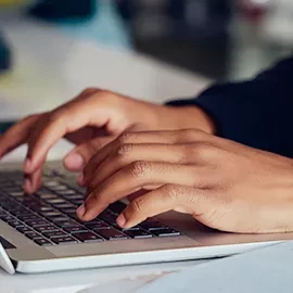 Person typing on laptop